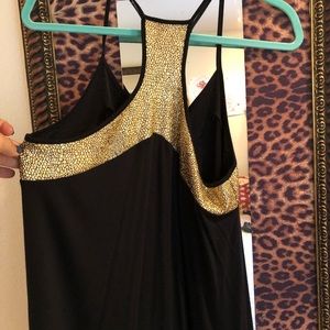 Flowy black tank with gold detailing around trim